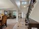 Elegant foyer with soaring ceilings, tile flooring, and wrought iron staircase at 10371 Knollside Dr, Parker, CO 80134