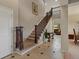Elegant foyer with soaring ceilings, tile flooring, and a staircase with wood and iron details at 10371 Knollside Dr, Parker, CO 80134