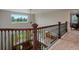 Open hallway with decorative railing overlooking the living room, offering bright natural light at 10371 Knollside Dr, Parker, CO 80134