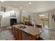 Open kitchen island featuring a stainless steel sink, dishwasher, and barstool seating overlooking the living area at 10371 Knollside Dr, Parker, CO 80134