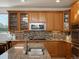 Beautiful kitchen with oak cabinets, stainless steel appliances, granite counters, and stylish tile backsplash at 10371 Knollside Dr, Parker, CO 80134