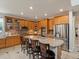 Well-appointed kitchen featuring stainless appliances, granite countertops, oak cabinets, and tile flooring at 10371 Knollside Dr, Parker, CO 80134