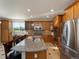 Well-equipped kitchen boasting stainless steel appliances, oak cabinets, granite counters, and tile backsplash at 10371 Knollside Dr, Parker, CO 80134