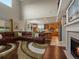 Spacious living room with vaulted ceilings, fireplace, and open access to the well-equipped kitchen at 10371 Knollside Dr, Parker, CO 80134