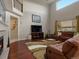 Inviting living room featuring soaring ceilings, a cozy fireplace, and a comfortable leather sectional sofa at 10371 Knollside Dr, Parker, CO 80134