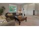 Cozy living room with comfortable seating, decorative accents, and a view of the front yard at 10371 Knollside Dr, Parker, CO 80134