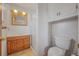 Well-lit bathroom features a glass enclosed shower, wooden vanity, and medicine cabinet at 12060 W Carolina Dr, Lakewood, CO 80228