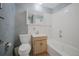 Bathroom featuring blue accents, vanity and combined tub and shower with neutral tile at 12060 W Carolina Dr, Lakewood, CO 80228