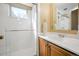 Bright bathroom with a glass-enclosed shower, vanity, and mirror, creating a refreshing and modern space at 12060 W Carolina Dr, Lakewood, CO 80228