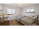 Cozy bedroom with carpet, natural light, dresser and floral bedding, creating a warm and inviting space at 12060 W Carolina Dr, Lakewood, CO 80228