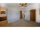 Comfortable bedroom featuring carpet, natural light and access to a convenient en-suite bathroom at 12060 W Carolina Dr, Lakewood, CO 80228