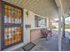 Inviting front porch with decorative ironwork, a cozy bench, and classic architectural details at 12060 W Carolina Dr, Lakewood, CO 80228