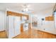 Functional kitchen with white appliances, wood cabinets, and easy access to dining area at 12060 W Carolina Dr, Lakewood, CO 80228