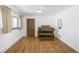 Sunlit room featuring hardwood floors, a window, and classic organ at 12060 W Carolina Dr, Lakewood, CO 80228