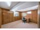 Dedicated office space featuring wood paneling, carpeted floor and built in desk and shelves at 12060 W Carolina Dr, Lakewood, CO 80228