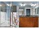 Bright bathroom with double sink vanity, soaking tub, glass shower enclosure and window at 2949 Emporia Ct, Denver, CO 80238