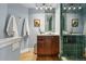 Bright bathroom with green tiled shower, wood vanity and decor creating a spa-like ambiance at 2949 Emporia Ct, Denver, CO 80238