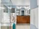 Bright bathroom with double sink vanity, soaking tub, glass shower enclosure and window at 2949 Emporia Ct, Denver, CO 80238