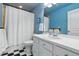 Bathroom featuring black and white checkered flooring, bright blue walls, shower and modern vanity at 2949 Emporia Ct, Denver, CO 80238