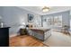 Comfortable bedroom with three windows, hardwood floors, overhead lighting, and soothing color palette at 2949 Emporia Ct, Denver, CO 80238