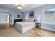 Spacious bedroom with hardwood floors, overhead lighting, with a window and open doorway to the hallway at 2949 Emporia Ct, Denver, CO 80238