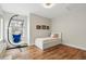 Bright bedroom with hardwood floors featuring daybed, window and hanging chair at 2949 Emporia Ct, Denver, CO 80238