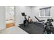 Bright exercise room with a stationary bike, weight bench, and dumbbells, perfect for home workouts at 2949 Emporia Ct, Denver, CO 80238