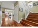 A spacious foyer with hardwood floors, staircase, and doorway into an adjoining room at 2949 Emporia Ct, Denver, CO 80238