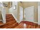Welcoming foyer with hardwood floors, stairs, a coat closet, and a view of the front door at 2949 Emporia Ct, Denver, CO 80238