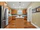 Spacious kitchen includes stainless steel appliances and island with pendant lighting at 2949 Emporia Ct, Denver, CO 80238