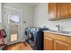 Modern laundry room with front-load washer and dryer and utility sink at 2949 Emporia Ct, Denver, CO 80238