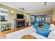 Cozy living room featuring a fireplace, hardwood floors, and a view of the dining room at 2949 Emporia Ct, Denver, CO 80238