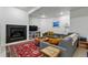 Inviting living room with a fireplace, plush seating, colorful pillows, and decor on shelves, perfect for relaxing at 2949 Emporia Ct, Denver, CO 80238