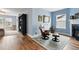Living room featuring a chair, bookshelves, fire place, and hardwood floors at 2949 Emporia Ct, Denver, CO 80238