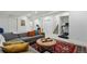 Relaxing living room with couch, patterned rug, modern decor, and workout equipment for healthy living at 2949 Emporia Ct, Denver, CO 80238