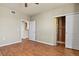 Bright bedroom featuring wood floors, a ceiling fan, a closet, and a view to the kitchen area at 5537 Lewis Ct # 101, Arvada, CO 80002