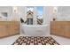 Bright bathroom features a soaking tub, dual sinks, and a geometric-patterned rug at 2351 N Emerson St, Denver, CO 80205