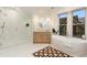 Bright bathroom boasts a soaking tub, glass enclosed shower, and dual sinks at 2351 N Emerson St, Denver, CO 80205