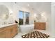 Bright bathroom features a soaking tub, dual sinks, and a geometric-patterned rug at 2351 N Emerson St, Denver, CO 80205