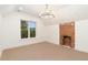 Empty bedroom has neutral carpet, a bricked-in fireplace, and a window at 2351 N Emerson St, Denver, CO 80205