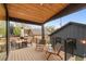 Outdoor deck has a wood ceiling and is furnished with table and chairs at 2351 N Emerson St, Denver, CO 80205