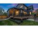 A modern house showcases a beautiful deck, dark siding and well-manicured landscaping at 2351 N Emerson St, Denver, CO 80205