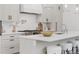 Bright kitchen features white cabinets, stainless appliances, and an island with bar stool seating at 2351 N Emerson St, Denver, CO 80205