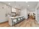 Open kitchen with a large island, white countertops, pendant lighting, modern cabinets, and an open view to the living area at 2351 N Emerson St, Denver, CO 80205
