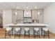 Modern kitchen with a large island, white countertops, pendant lighting, sleek cabinets, and stylish bar stools at 2351 N Emerson St, Denver, CO 80205