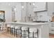 Bright kitchen features pendant lighting over a spacious island with seating and modern appliances at 2351 N Emerson St, Denver, CO 80205