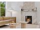 Modern living room with a sleek fireplace, neutral furniture, contemporary decor, and abundant natural light from the window at 2351 N Emerson St, Denver, CO 80205