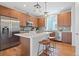 Bright kitchen with stainless appliances, light wood cabinetry, white countertops, and breakfast bar at 8711 E Hampden Ave # 22, Denver, CO 80231