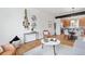 Spacious living area featuring hardwood floors, chic decor, and seamless flow into the kitchen and dining space at 8711 E Hampden Ave # 22, Denver, CO 80231