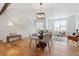 Bright living room features hardwood floors, many windows, and a modern pendant light at 8711 E Hampden Ave # 22, Denver, CO 80231
